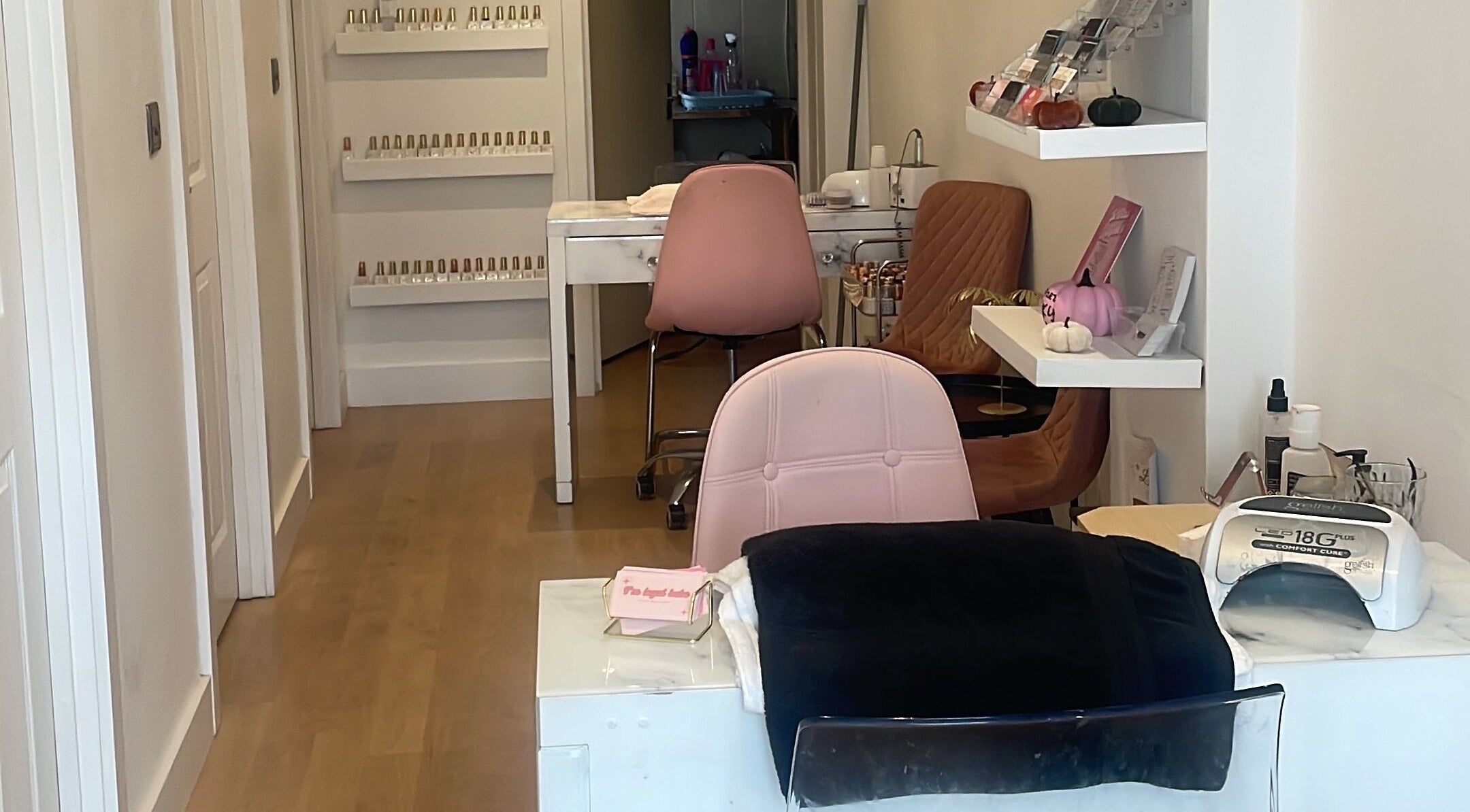 Inside Bronzed Beauty, Bournemouth, England, GB: stylish nail stations and vibrant decor for relaxing treatments.