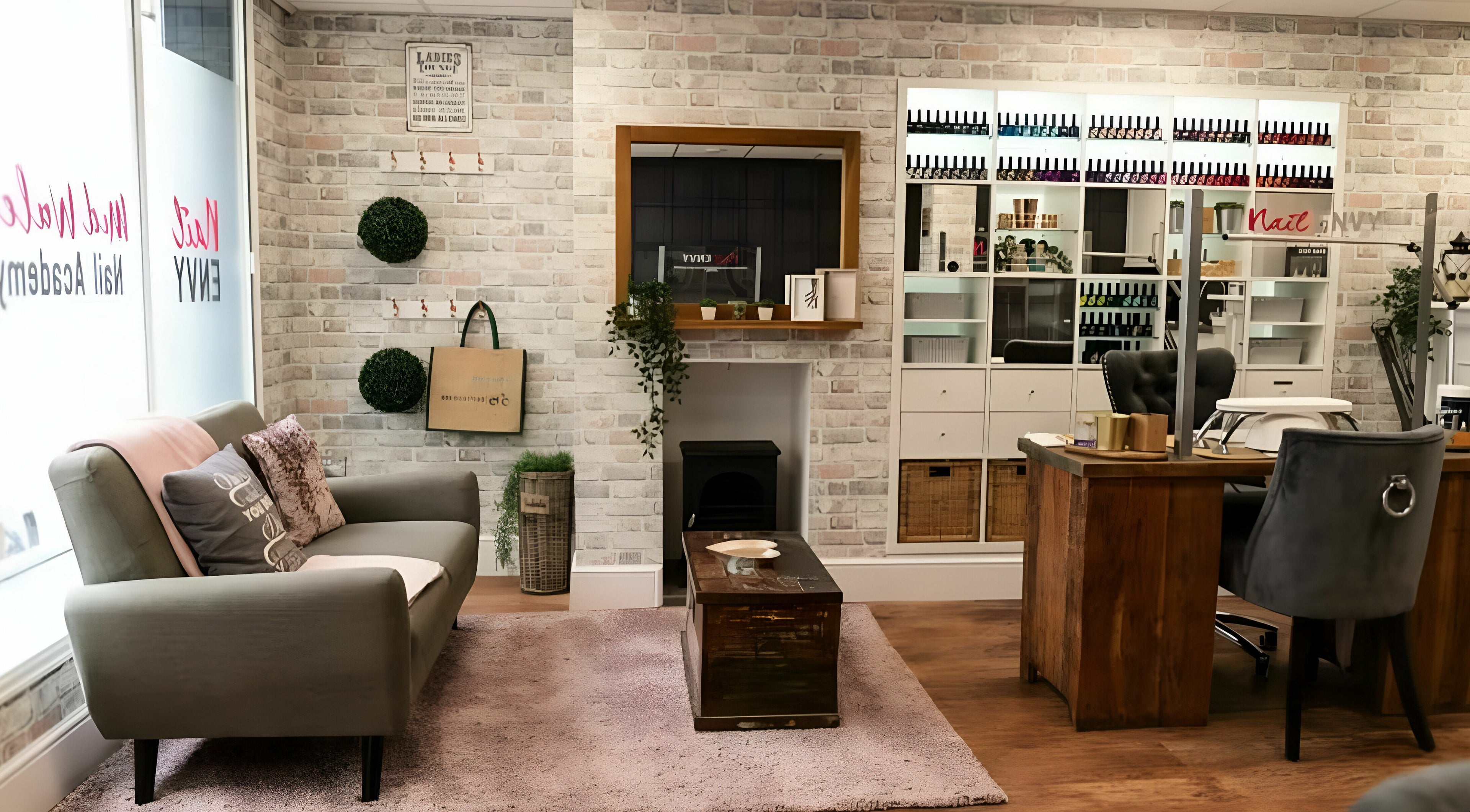Elegant interior of Nail Envy-Mid Wales in Newtown, Wales, GB showcasing cozy sofa and chic nail polish display.