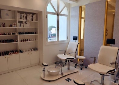 Elegant nail salon seating at Maison De Joelle- Mirdif, Dubai, AE. Bright, inviting space for beauty treatments.