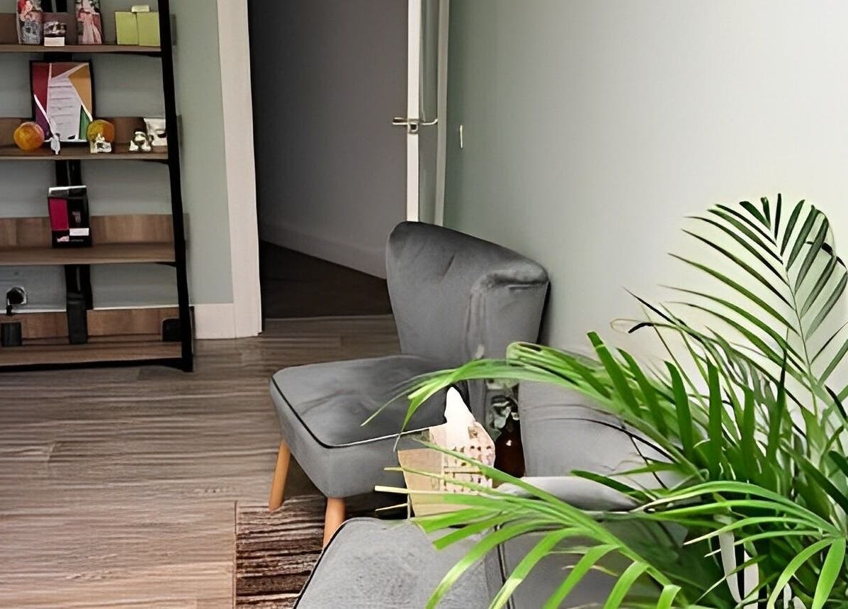 Cozy seating area with lush plants at Beauty by Jaki in Falkirk, Scotland, GB, offering a serene ambiance.