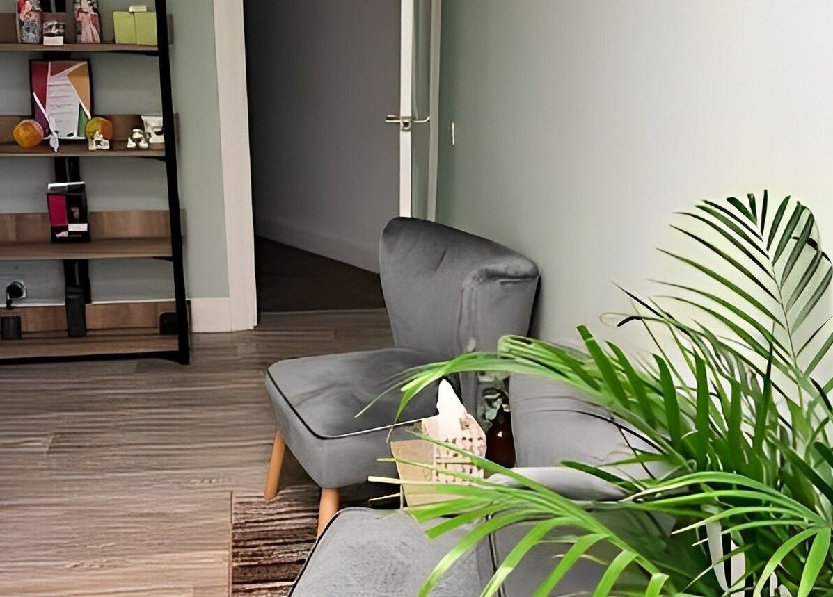 Cozy seating area with lush plants at Beauty by Jaki in Falkirk, Scotland, GB, offering a serene ambiance.