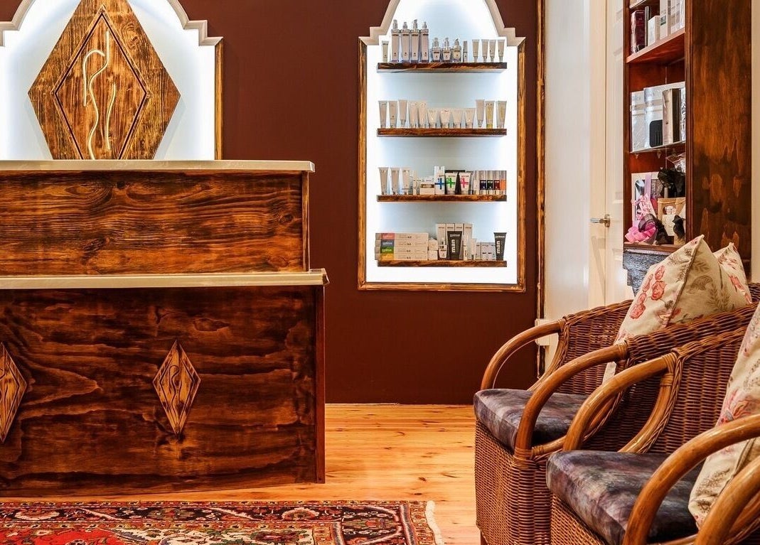 Inviting reception at Total Concept Salon & Spa, Gqeberha, Eastern Cape, ZA with cozy seating and product display.