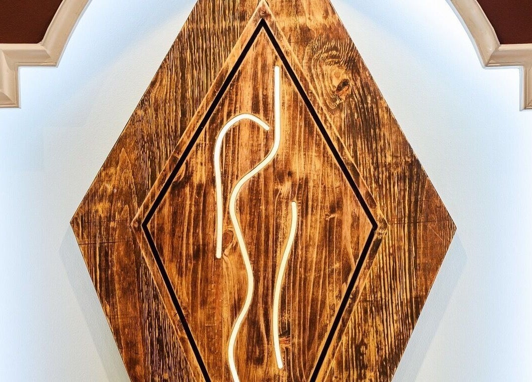 Artistic wooden wall decor at Total Concept Salon & Spa, Gqeberha, Eastern Cape, ZA, exuding rustic elegance.
