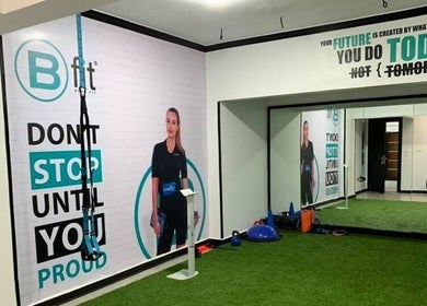 Interior of Body Fit Egypt EMS Maadi Branch, Cairo: workout area with motivational posters and fitness equipment.