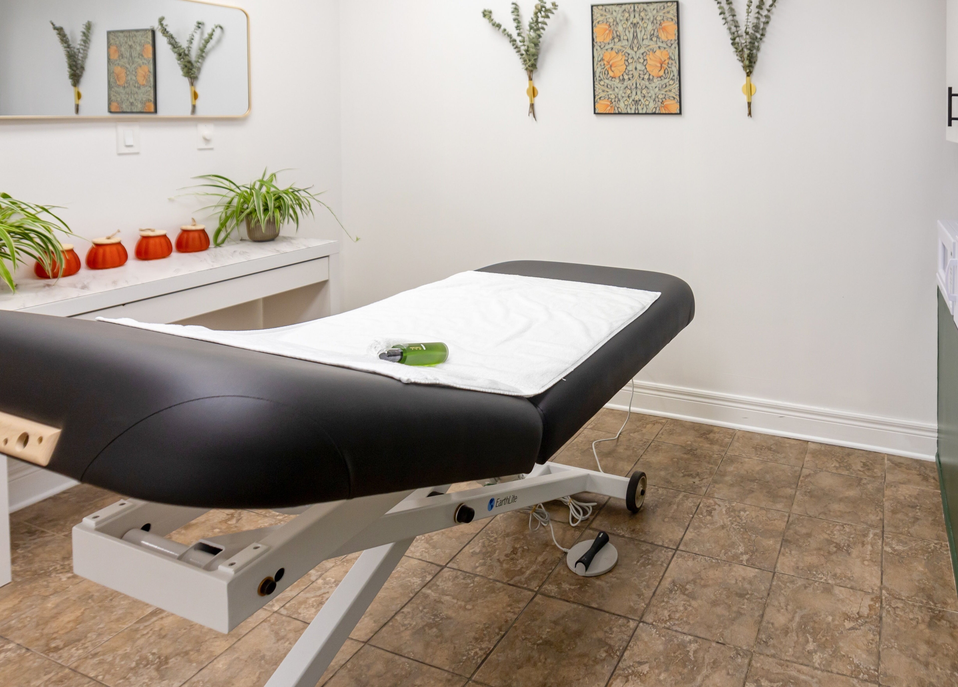 Calming treatment room at The Pampered Peach, Thorold, Ontario, CA featuring a massage table and soothing decor.