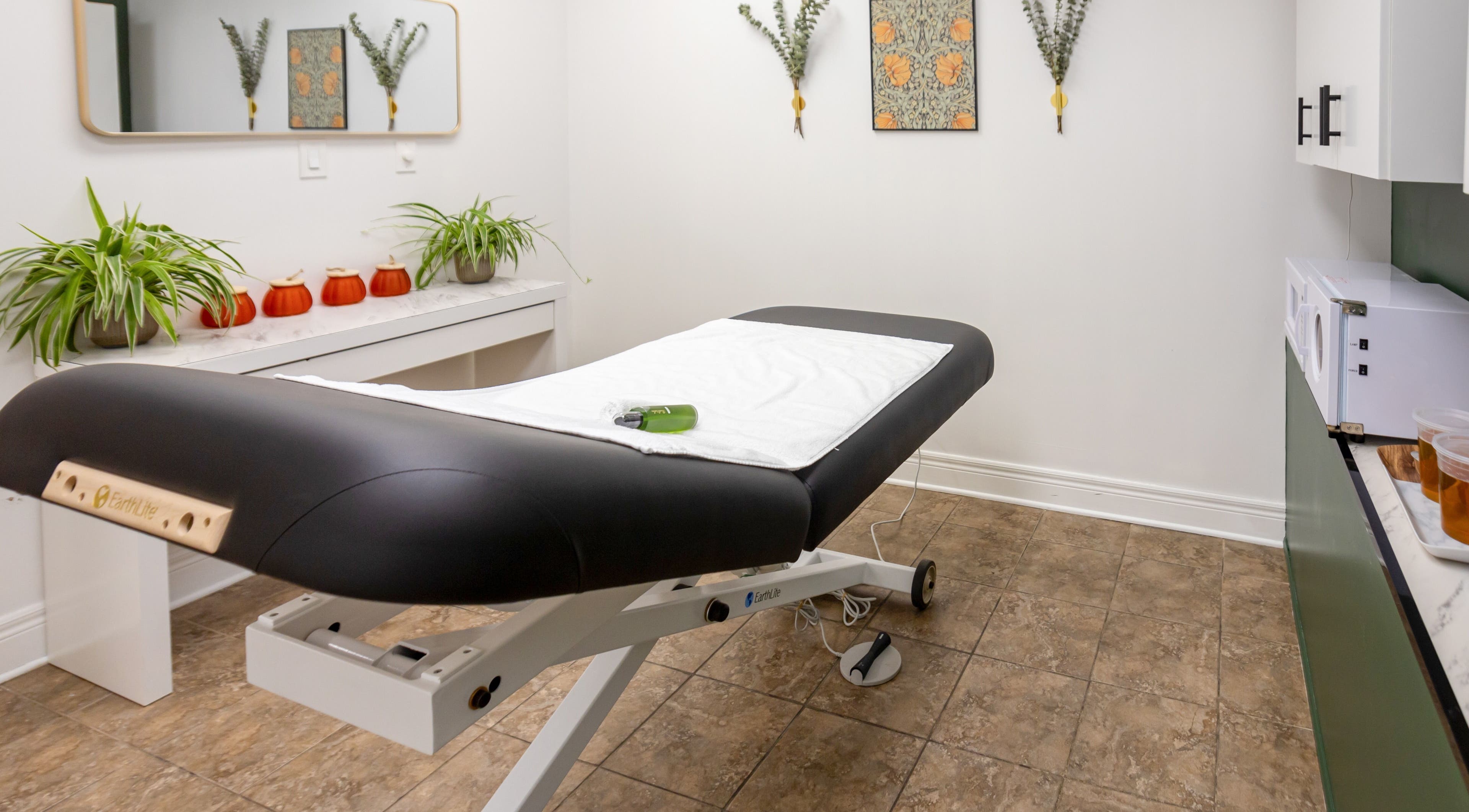 Calming treatment room at The Pampered Peach, Thorold, Ontario, CA featuring a massage table and soothing decor.