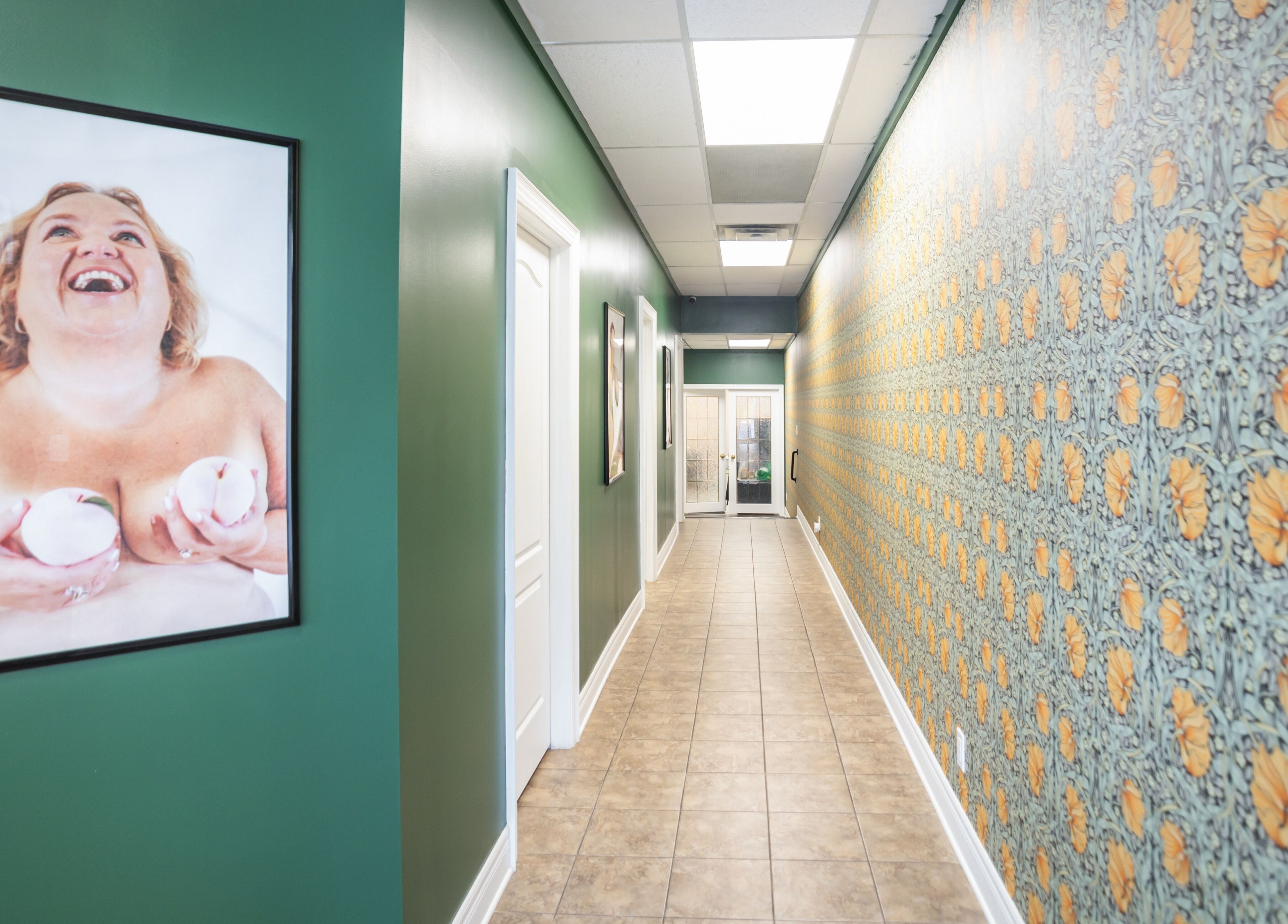 Colorful hallway at The Pampered Peach, Thorold, Ontario, CA, featuring vibrant wall art and bright lighting.