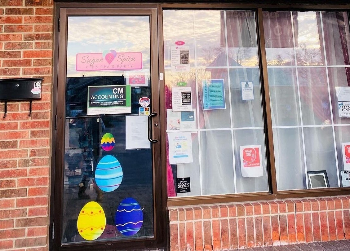 Front entrance of Sugar and Spice Kids Spa and Party in Hamilton, Ontario, CA showcasing vibrant window decor.