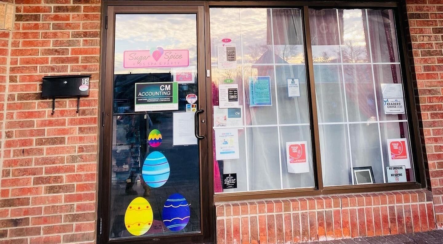 Front entrance of Sugar and Spice Kids Spa and Party in Hamilton, Ontario, CA showcasing vibrant window decor.