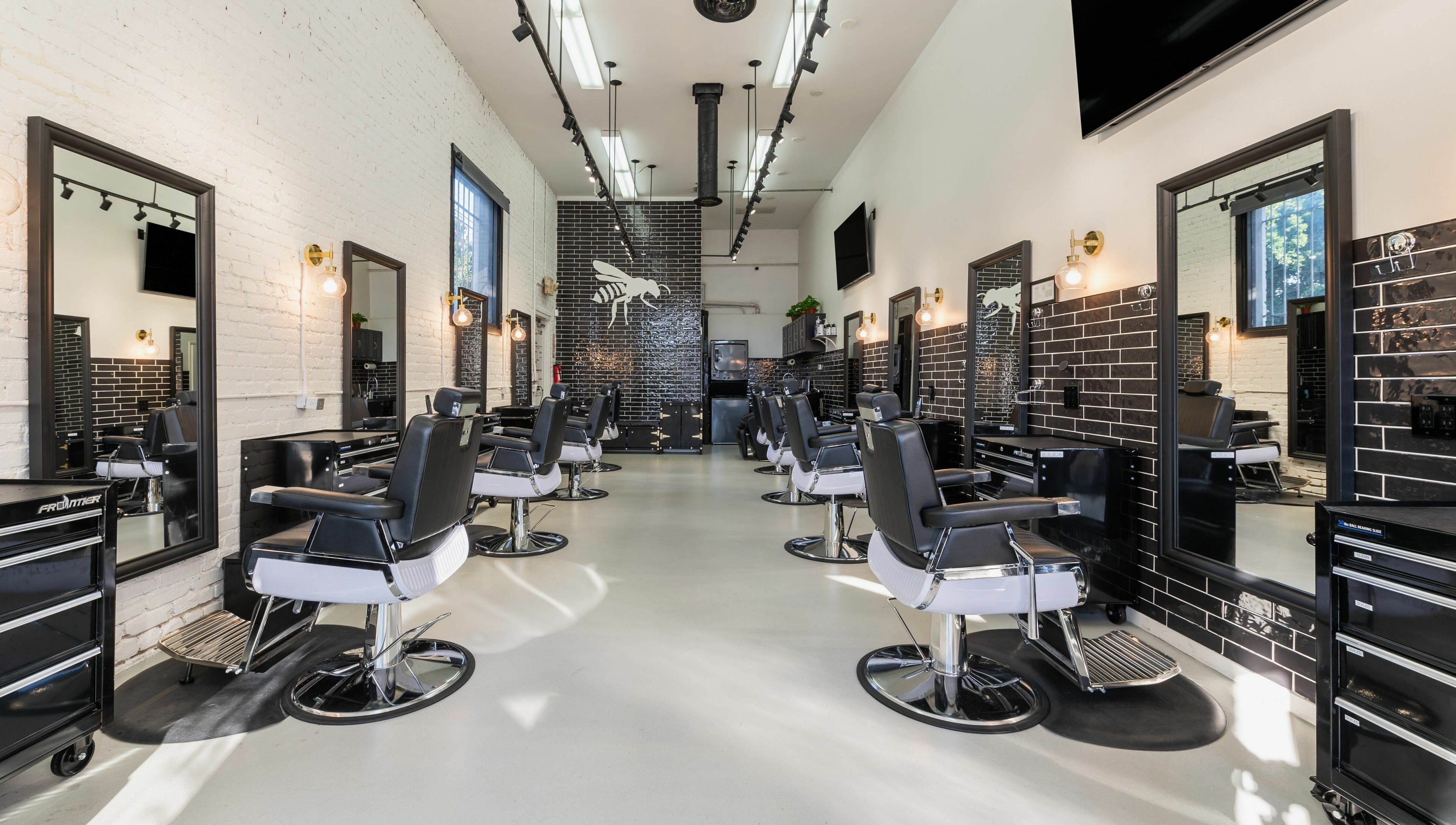 Modern interior of Buzzed Barbers West Hollywood in West Hollywood, California, US, showcasing stylish barber chairs.