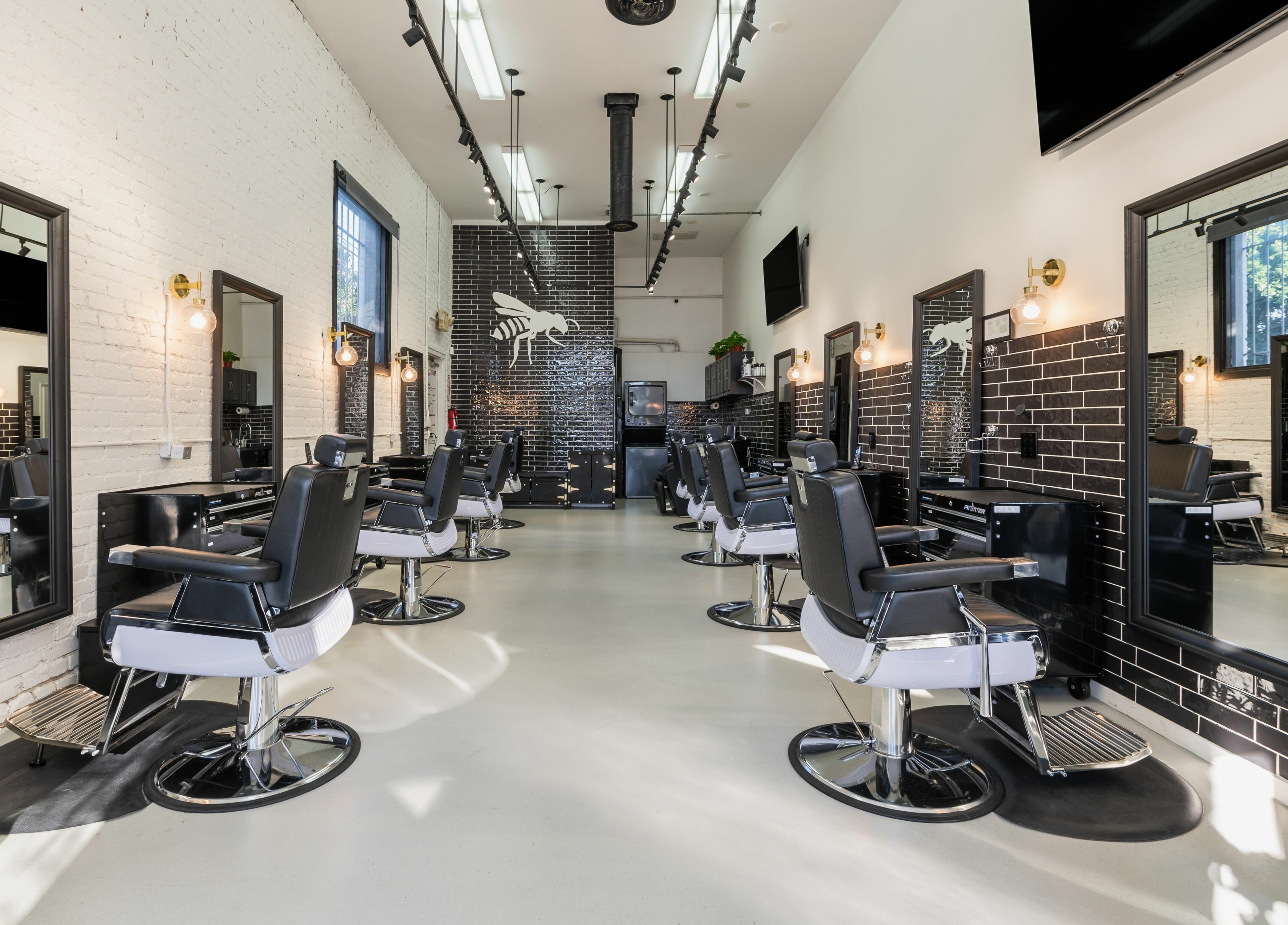 Modern interior of Buzzed Barbers West Hollywood in West Hollywood, California, US, showcasing stylish barber chairs.