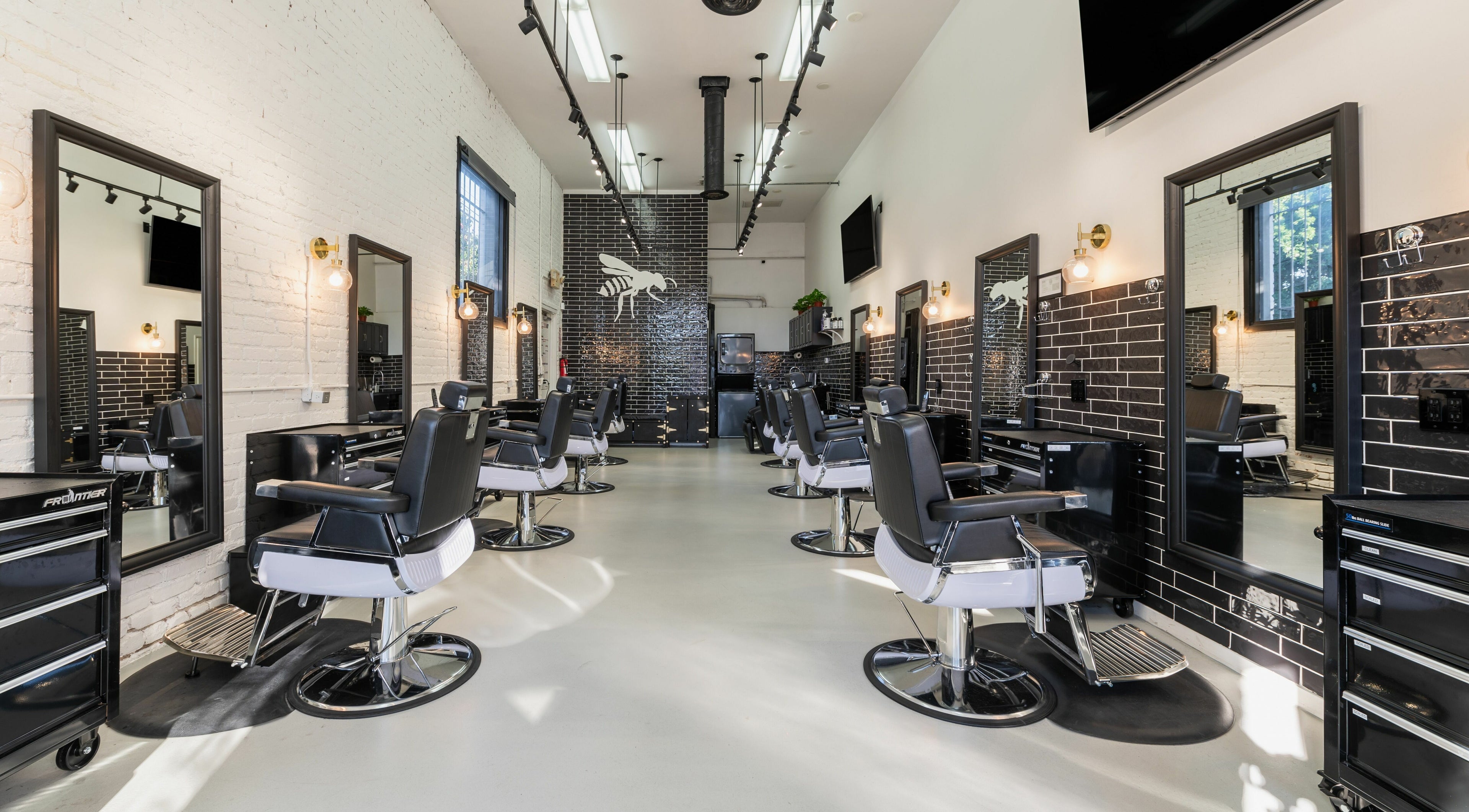 Modern interior of Buzzed Barbers West Hollywood in West Hollywood, California, US, showcasing stylish barber chairs.