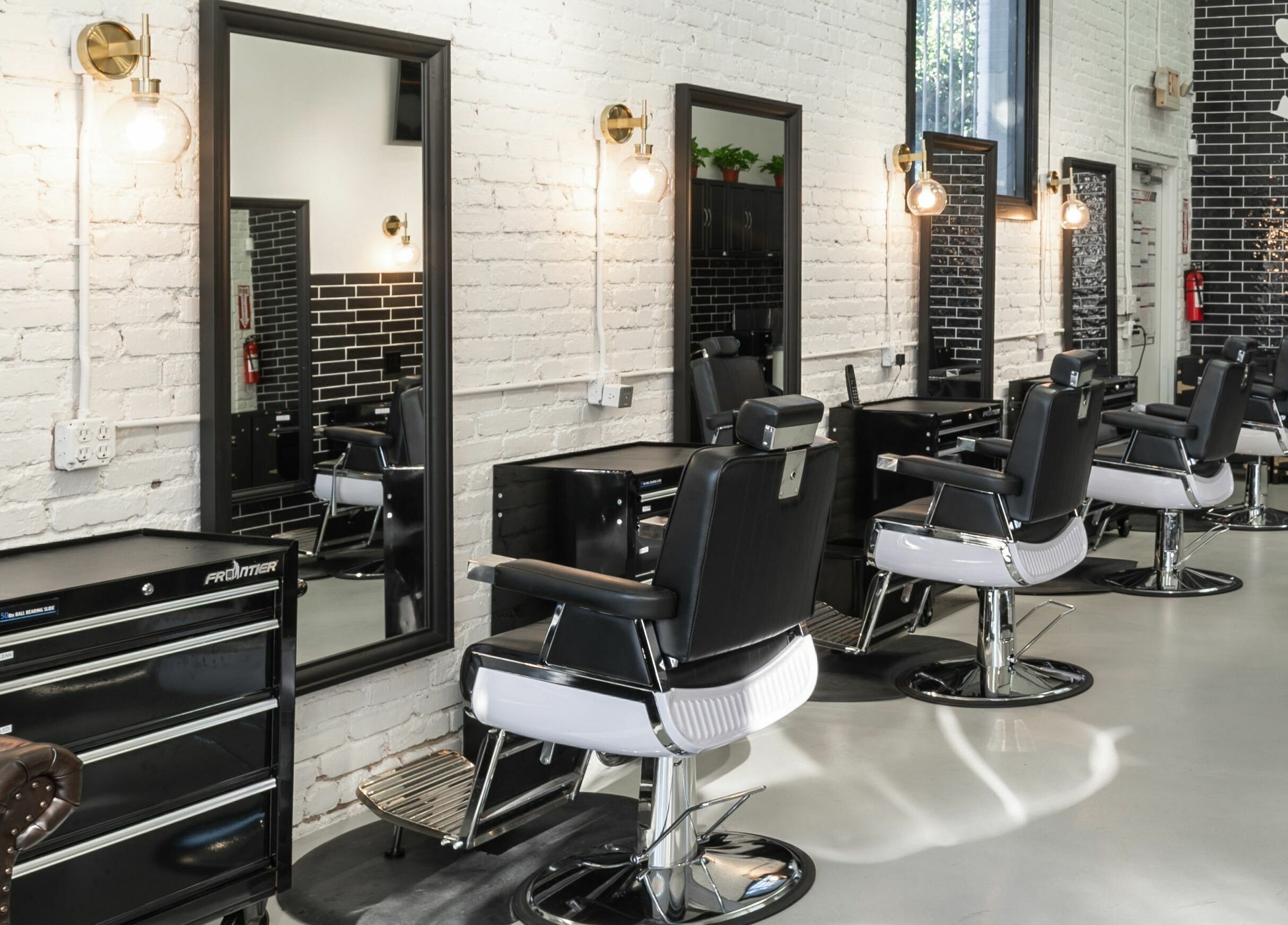 Modern interior of Buzzed Barbers West Hollywood in West Hollywood, California, US with stylish barber chairs.