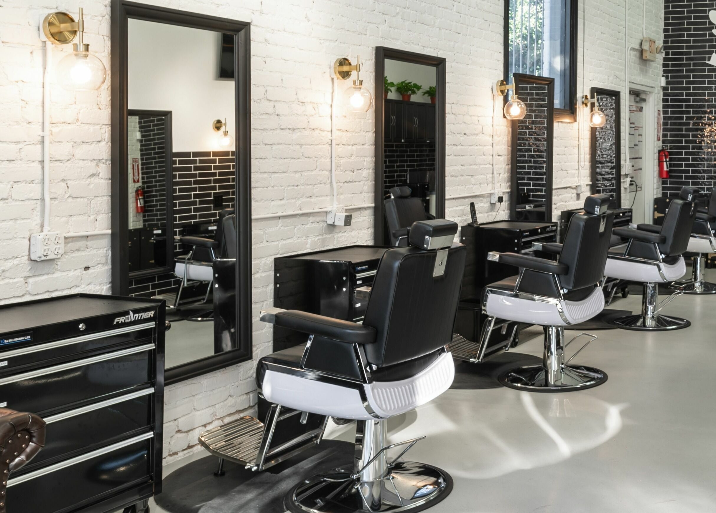 Modern interior of Buzzed Barbers West Hollywood in West Hollywood, California, US with stylish barber chairs.
