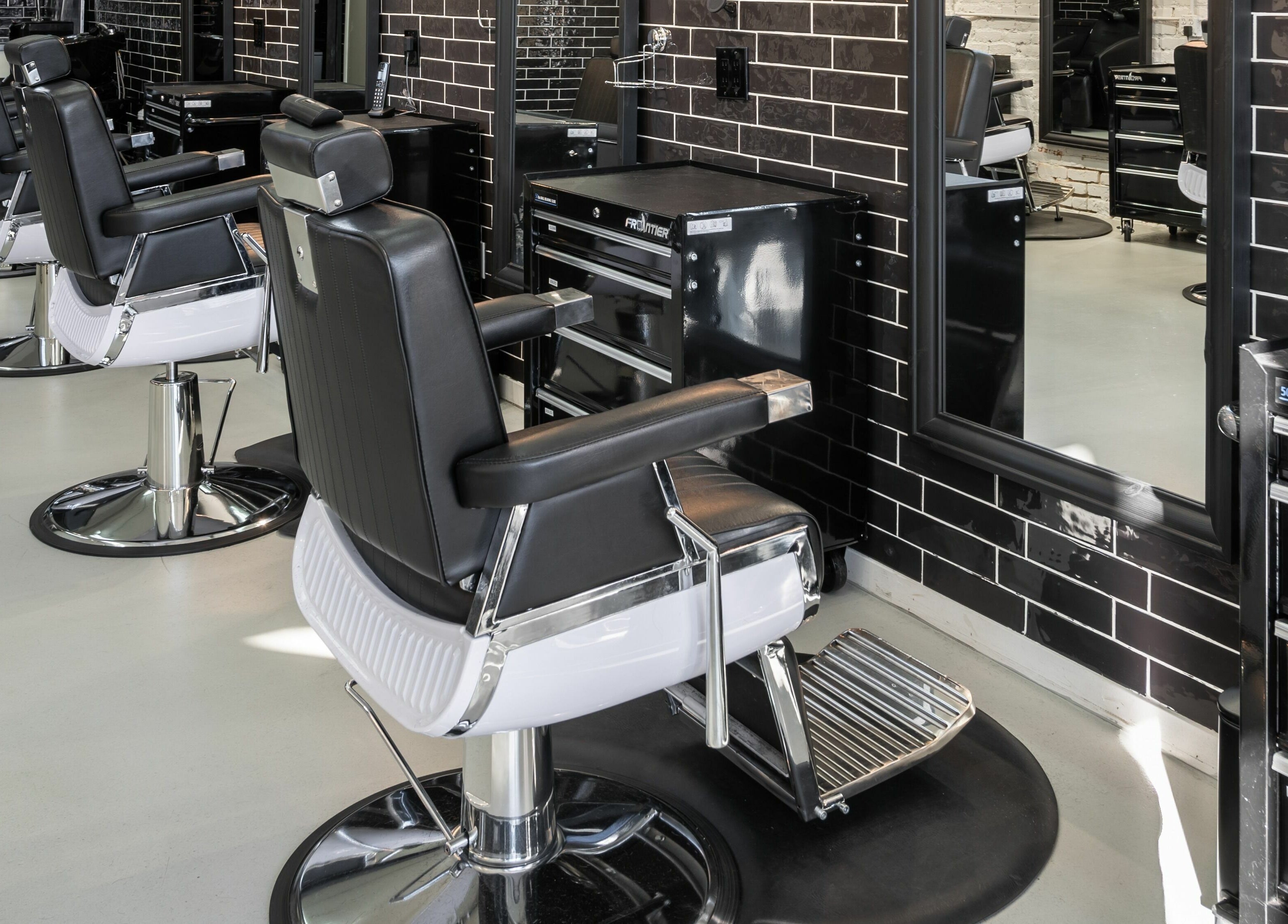 Modern barber chairs at Buzzed Barbers West Hollywood, California, US, showcasing sleek, stylish interior design.