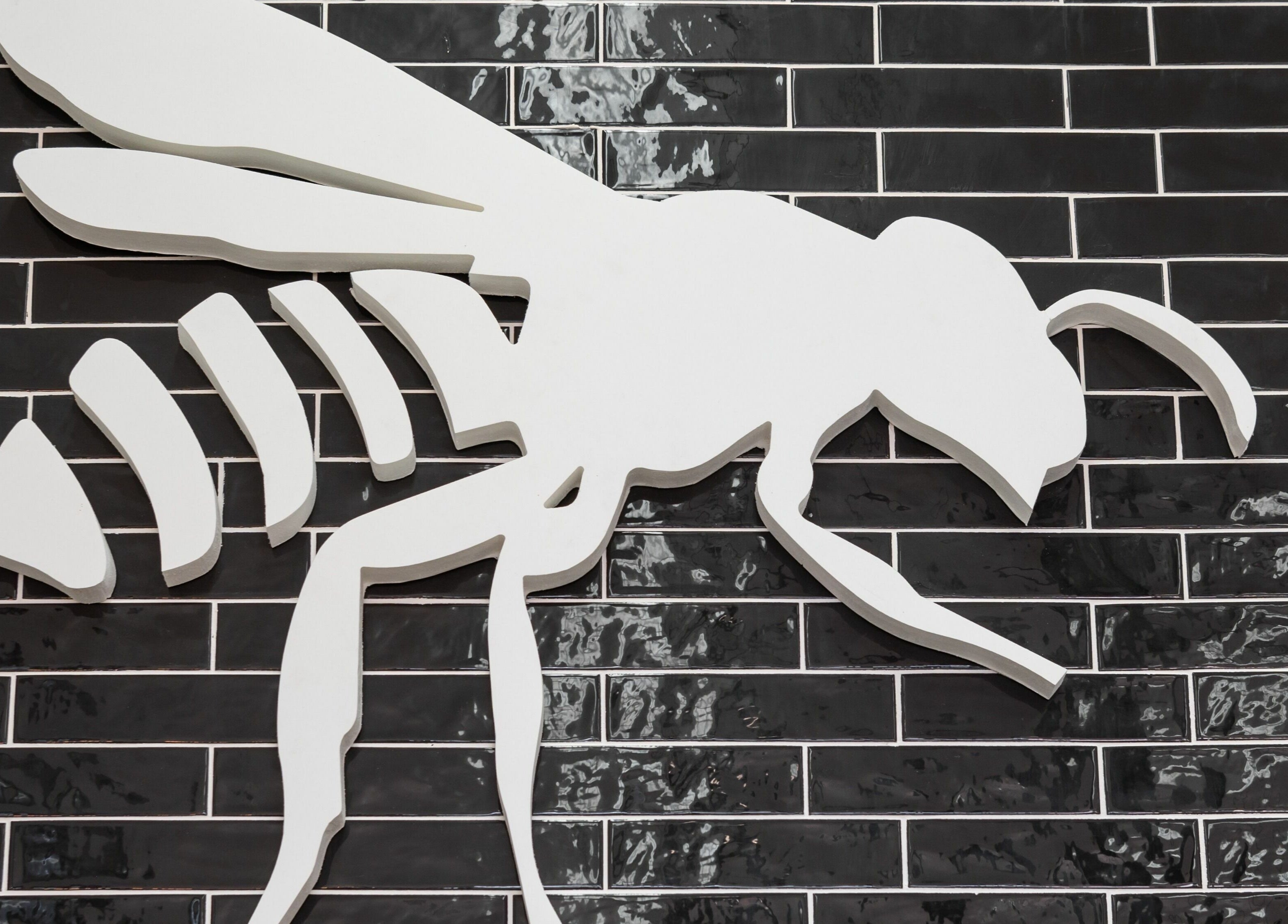 Bee logo mural at Buzzed Barbers West Hollywood, West Hollywood, California, US adds modern flair.