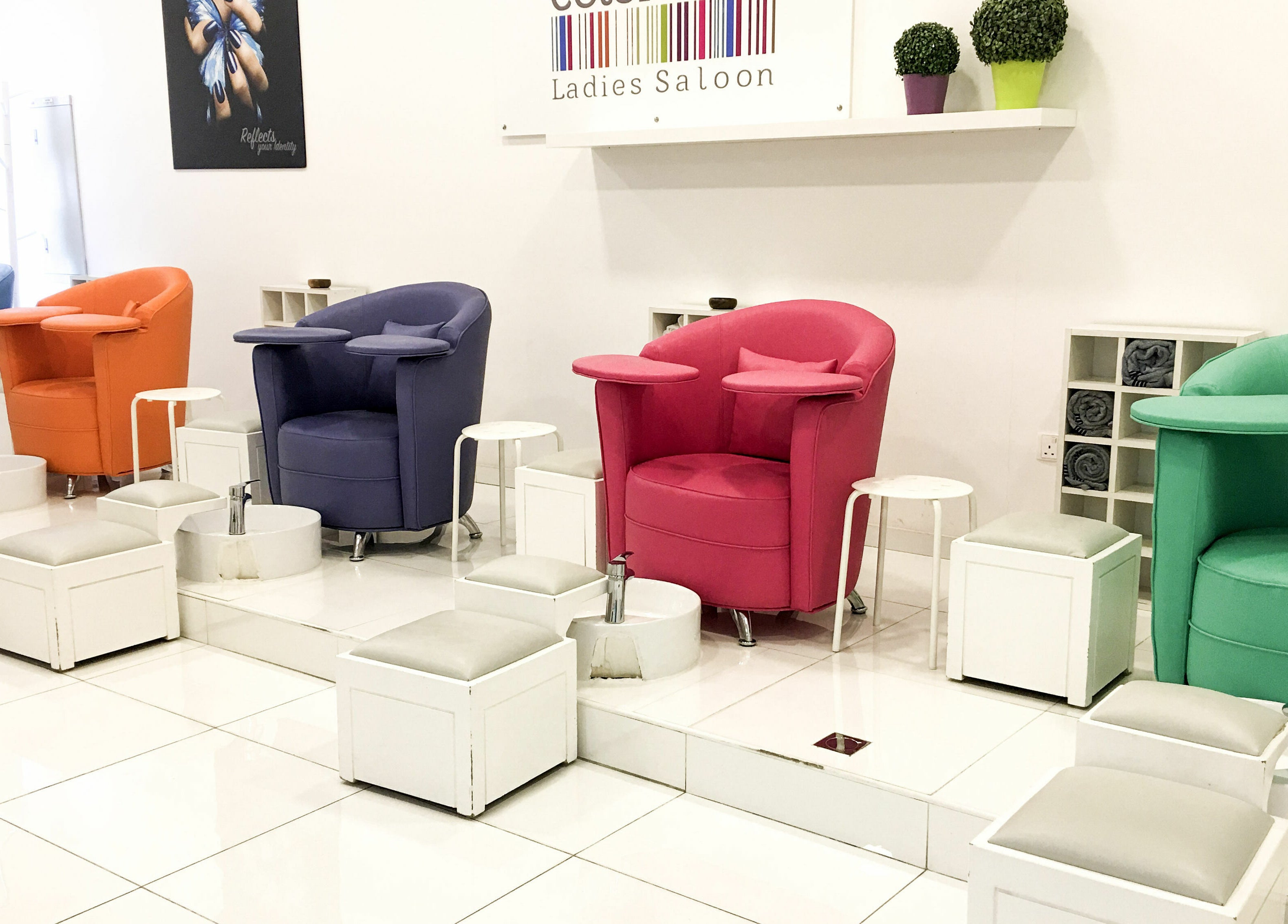 Colorful salon chairs at Colorcode Emirates Garden 2 Jumeirah Village Circle, Dubai, Dubai, AE, showcasing vibrant seating.