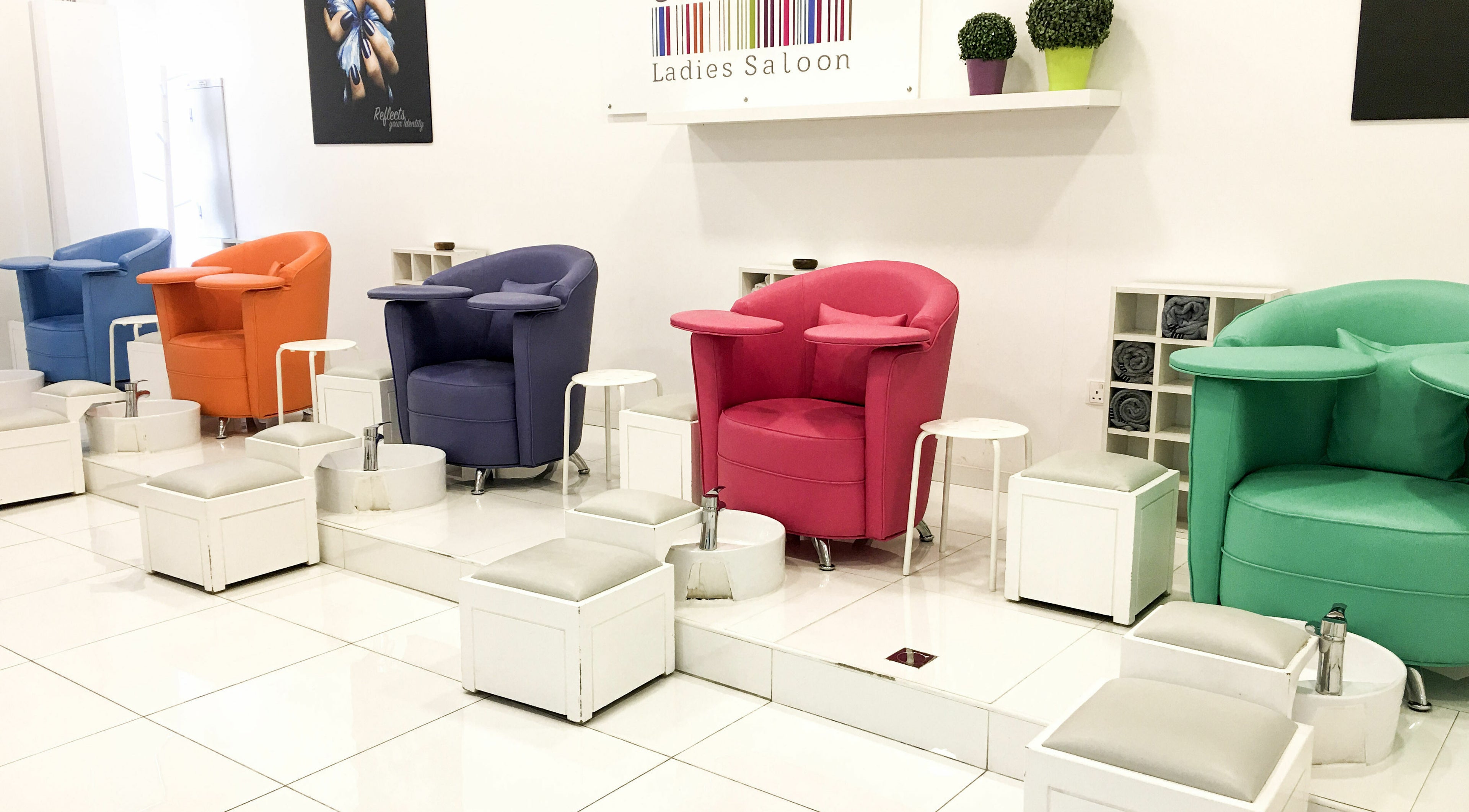 Colorful salon chairs at Colorcode Emirates Garden 2 Jumeirah Village Circle, Dubai, Dubai, AE, showcasing vibrant seating.