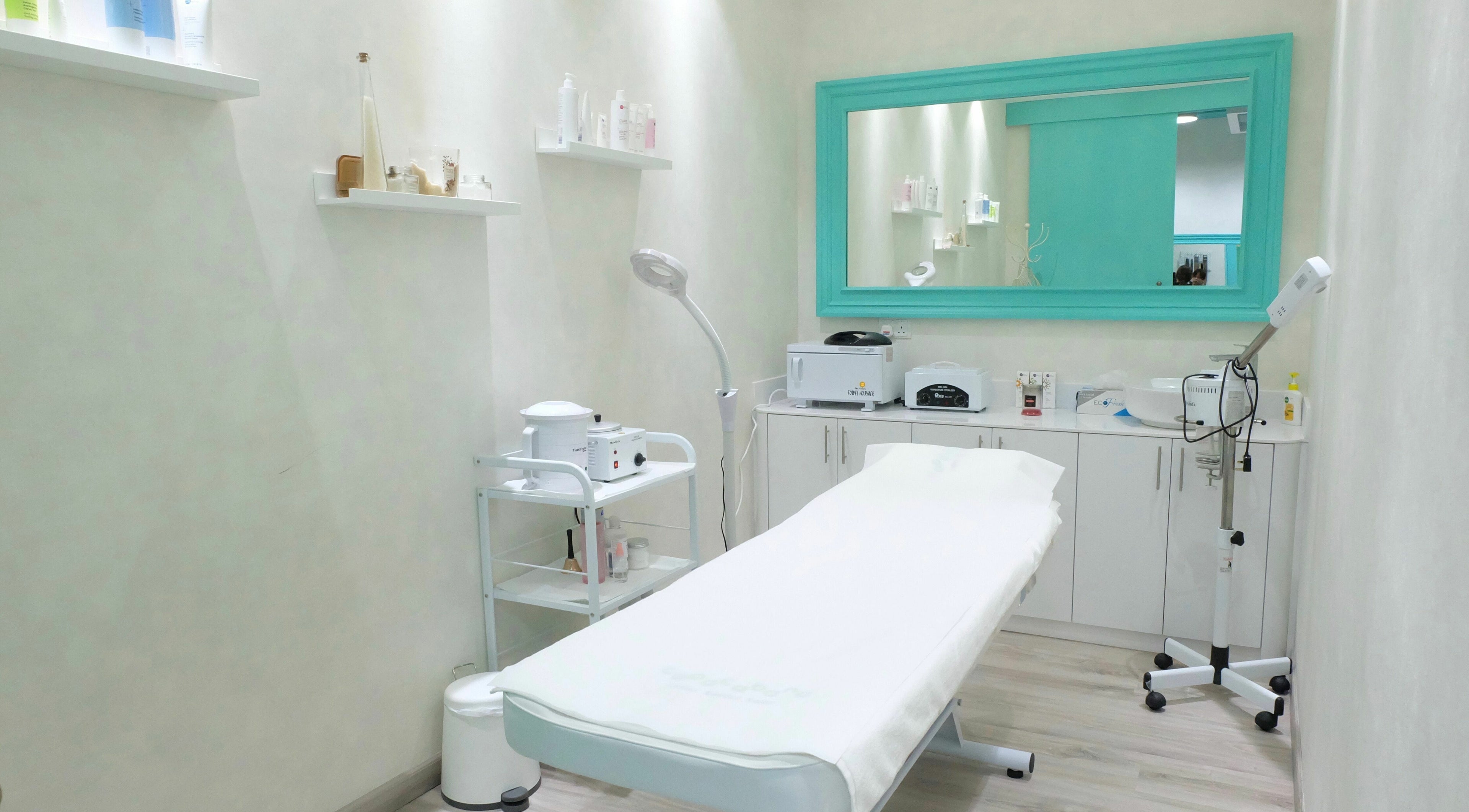 Copacabana spa treatment room with modern decor in Dubai, AE, featuring a massage table and skincare products.