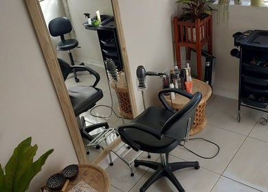 Modern salon interior at Hair By Amanda, Sandton, Gauteng, ZA showcases styling chair and mirror setup.