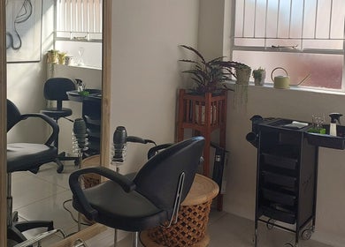 Elegant interior of Hair By Amanda, Sandton, Gauteng, ZA with styling chair and large mirror.
