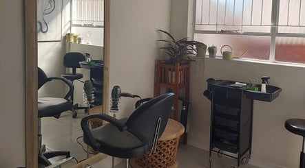 Elegant interior of Hair By Amanda, Sandton, Gauteng, ZA with styling chair and large mirror.