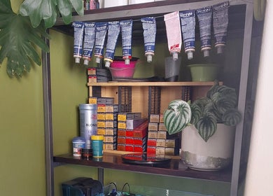 Hair By Amanda in Sandton, Gauteng, ZA, displays an array of hair color products on a stylish shelf.