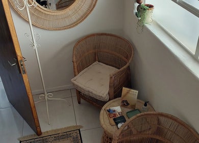 Inviting waiting area with wicker chairs at Hair By Amanda, Sandton, Gauteng, ZA.