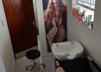 Cozy salon nook at Hair By Amanda in Sandton, Gauteng, ZA featuring a wash basin and elegant decor.