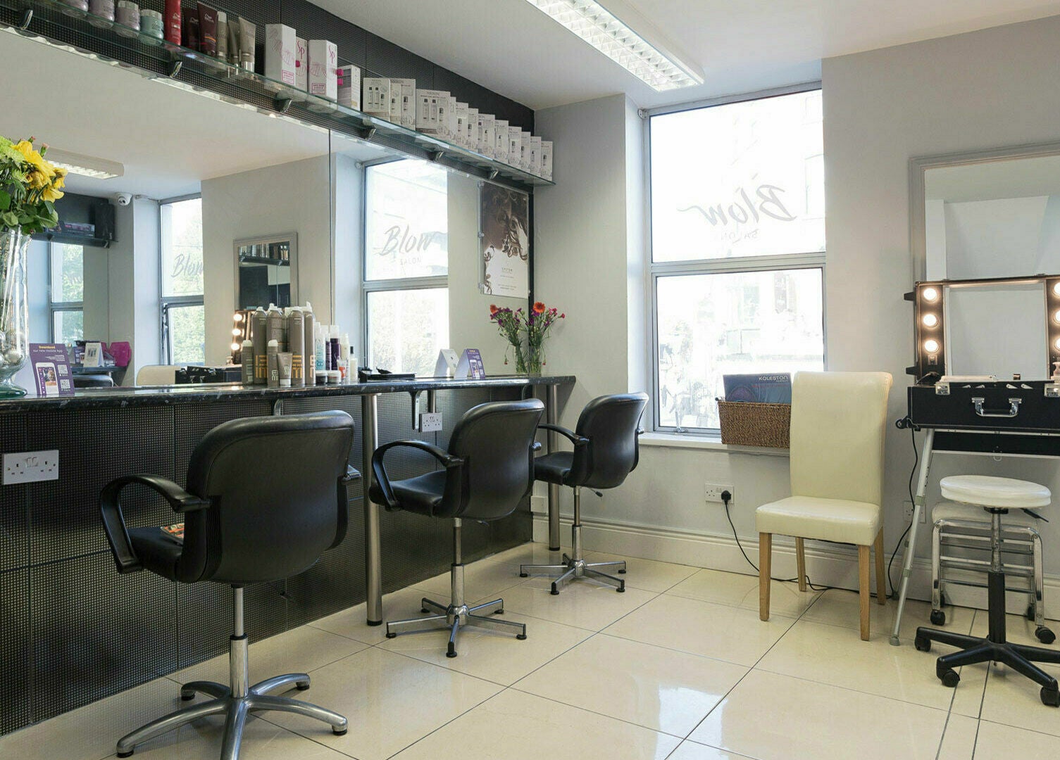 Modern salon interior at Blow Leeson Street, Dublin, County Dublin, IE, featuring sleek styling stations.