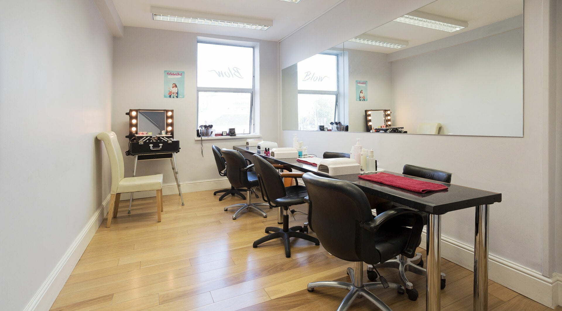 Elegant beauty station at Blow Leeson Street, Dublin, County Dublin, IE featuring sleek chairs and large mirrors.