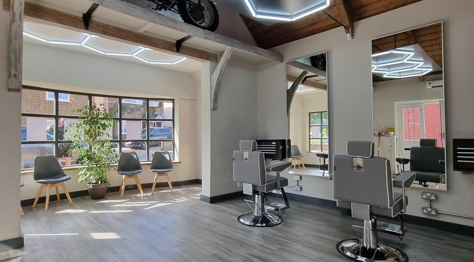 Modern barber chairs and stylish interior at The Gentlemen's Lounge Potton, Potton, England, GB.