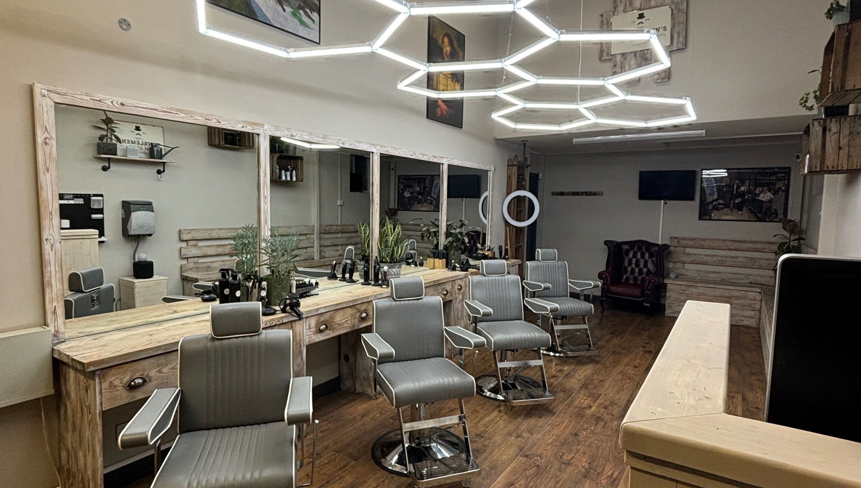 Modern barber chairs at The Gentlemen’s Lounge Biggleswade, Biggleswade, England, GB, showcasing elegance.