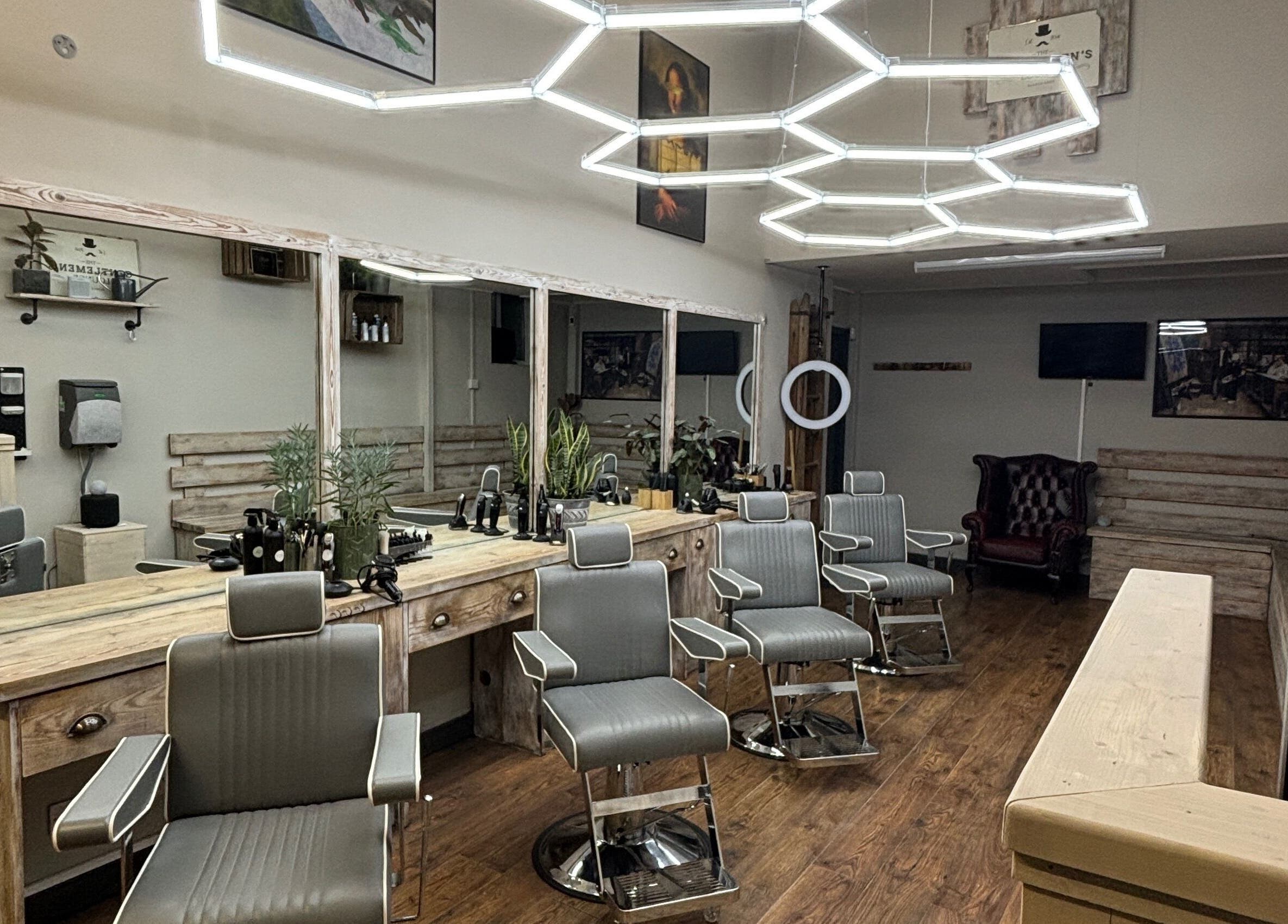 Modern barber chairs at The Gentlemen’s Lounge Biggleswade, Biggleswade, England, GB, showcasing elegance.