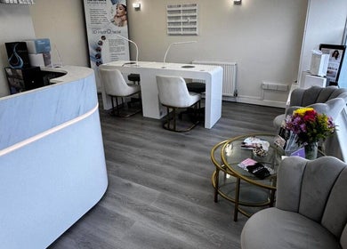 Modern interior of Salon Angels Beauty & Aesthetics, Caerphilly, Wales, GB with seating and floral decor.