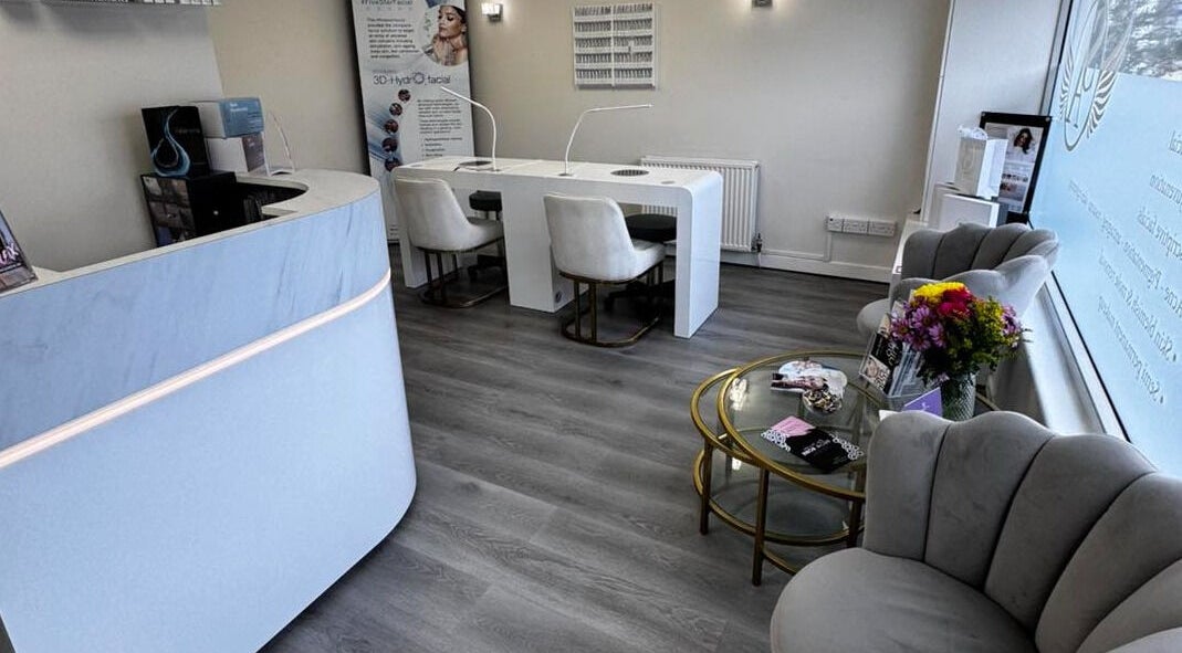 Modern interior of Salon Angels Beauty & Aesthetics, Caerphilly, Wales, GB with seating and floral decor.