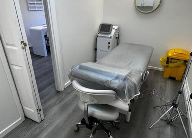 Treatment room at Salon Angels Beauty & Aesthetics, Caerphilly, Wales, GB, featuring a massage bed and equipment.
