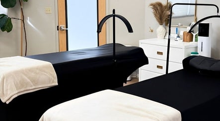 Luxurious treatment room at & Beauty Co., Citrus Heights, California, US with massage beds and calming decor.
