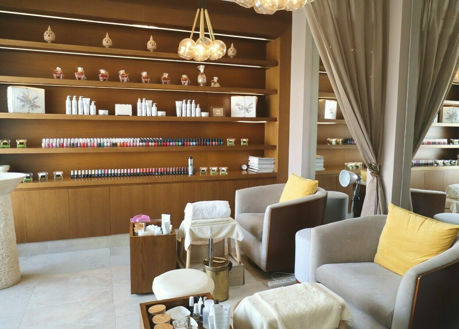 Inviting seating and nail polish display in Luban Spa, Dubai, AE for a serene and luxurious experience.