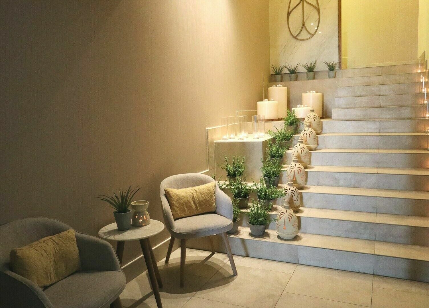 Elegant stairway with candles and plants at Luban Spa, Dubai, AE, offering a tranquil wellness ambience.