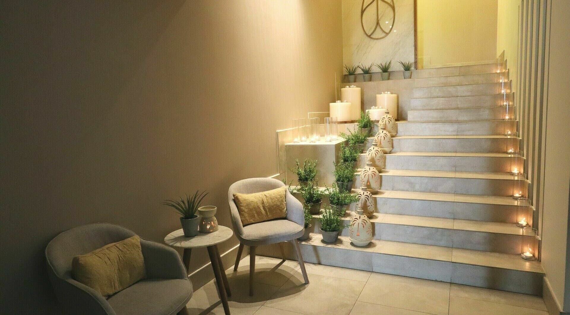 Elegant stairway with candles and plants at Luban Spa, Dubai, AE, offering a tranquil wellness ambience.