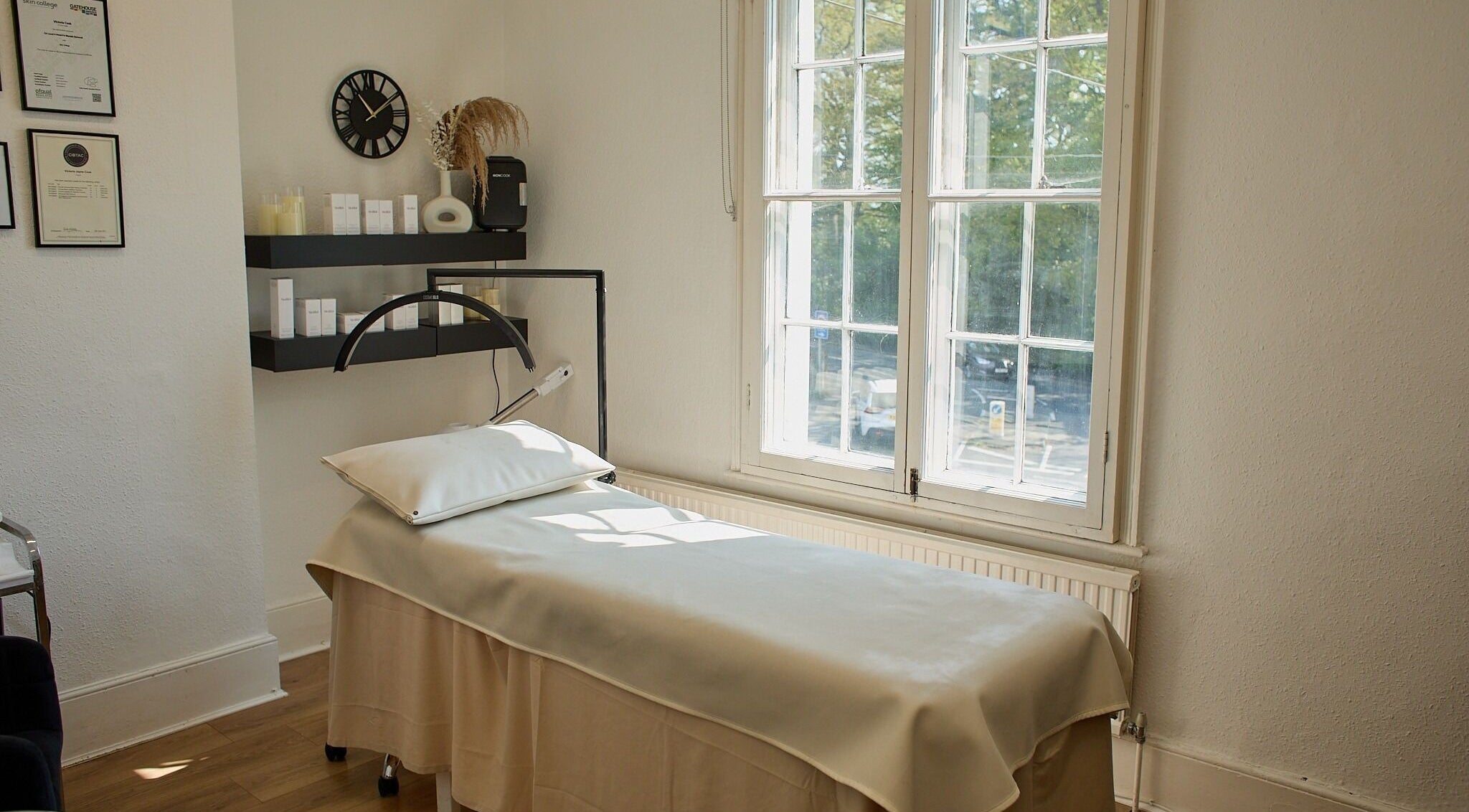 Bright treatment room at Victoria Jane Beauty, Chelmsford, England, GB, featuring a cozy massage bed near a window.