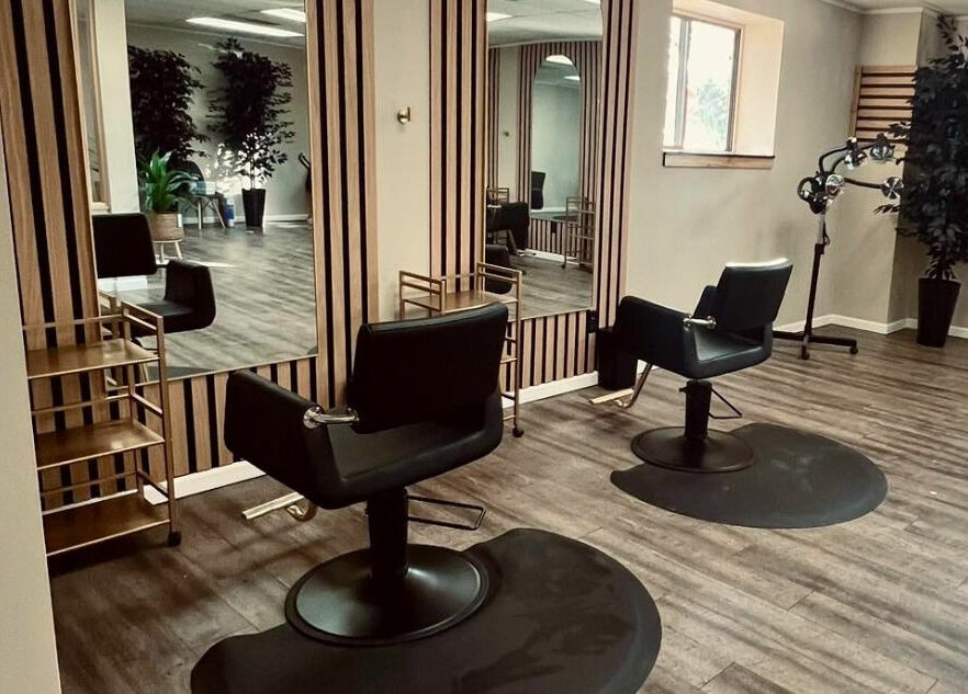 Chic salon chairs and mirrors at The Babe Kave, Flint, Michigan, US, showcasing elegant, modern interior design.