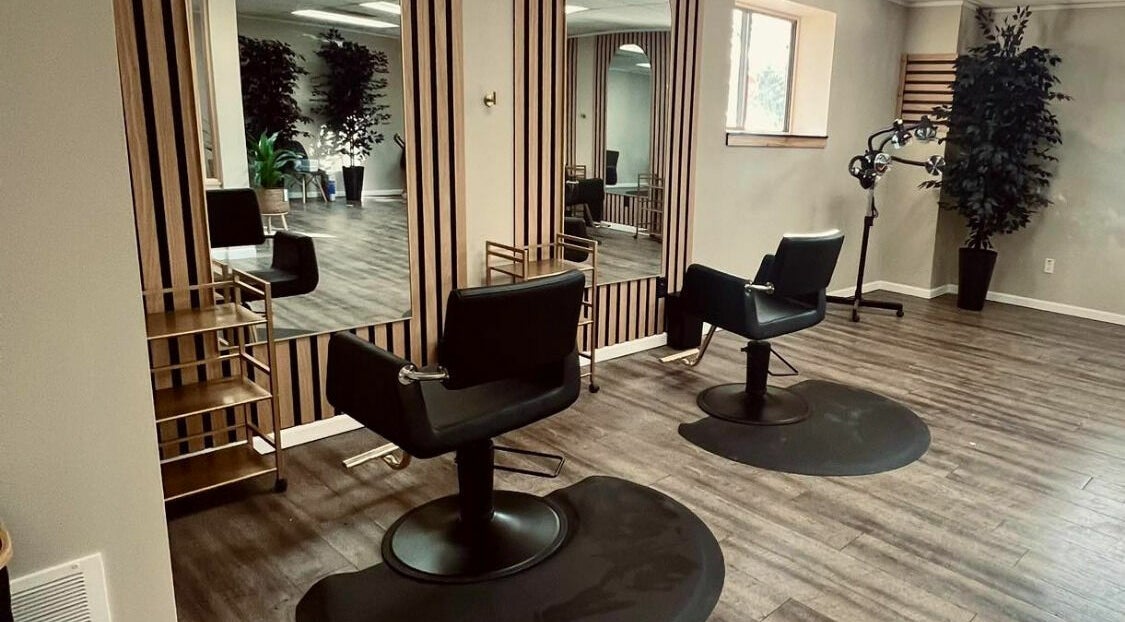 Chic salon chairs and mirrors at The Babe Kave, Flint, Michigan, US, showcasing elegant, modern interior design.