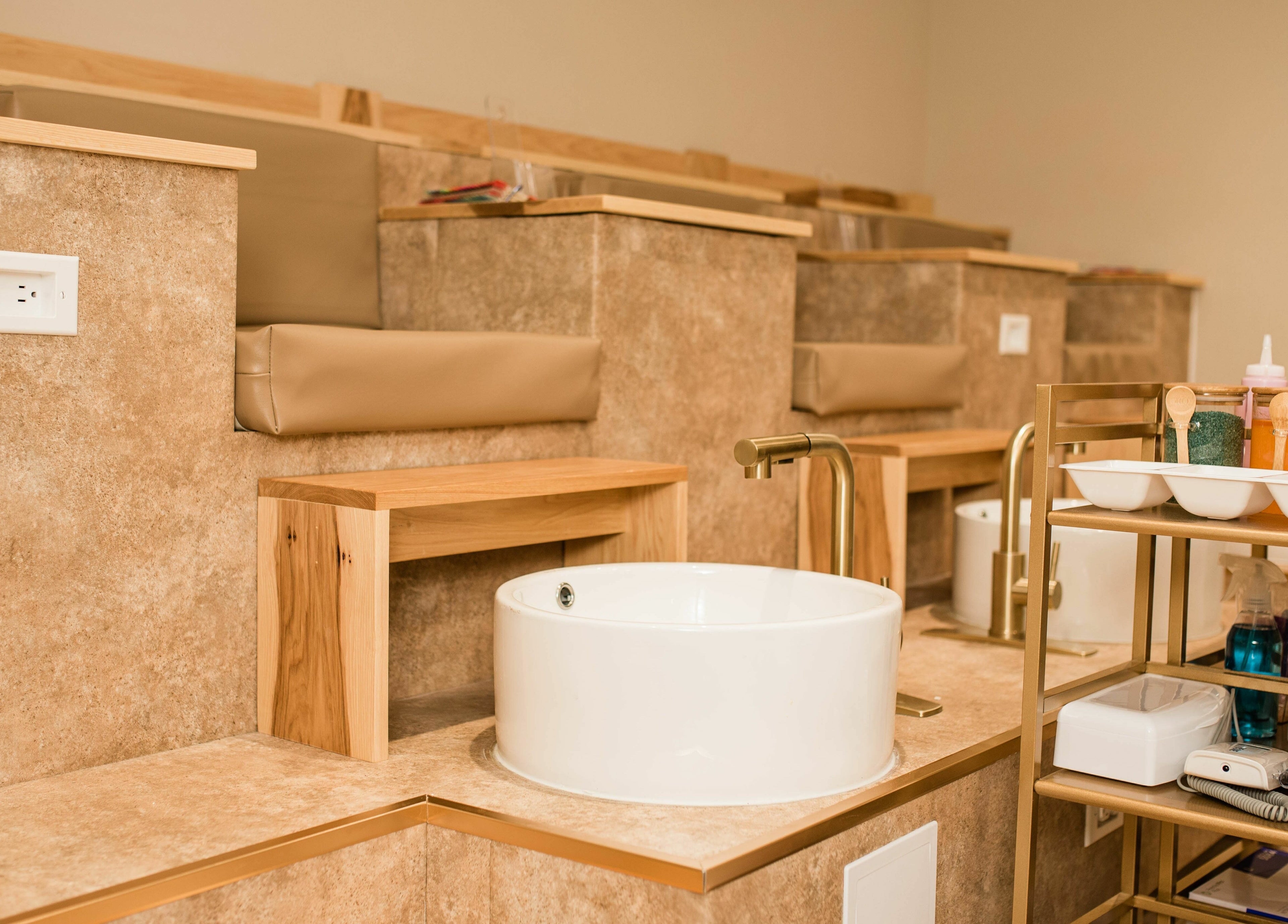 Elegant nail spa area at The Babe Kave, Flint, Michigan, US with plush seating and foot basins.