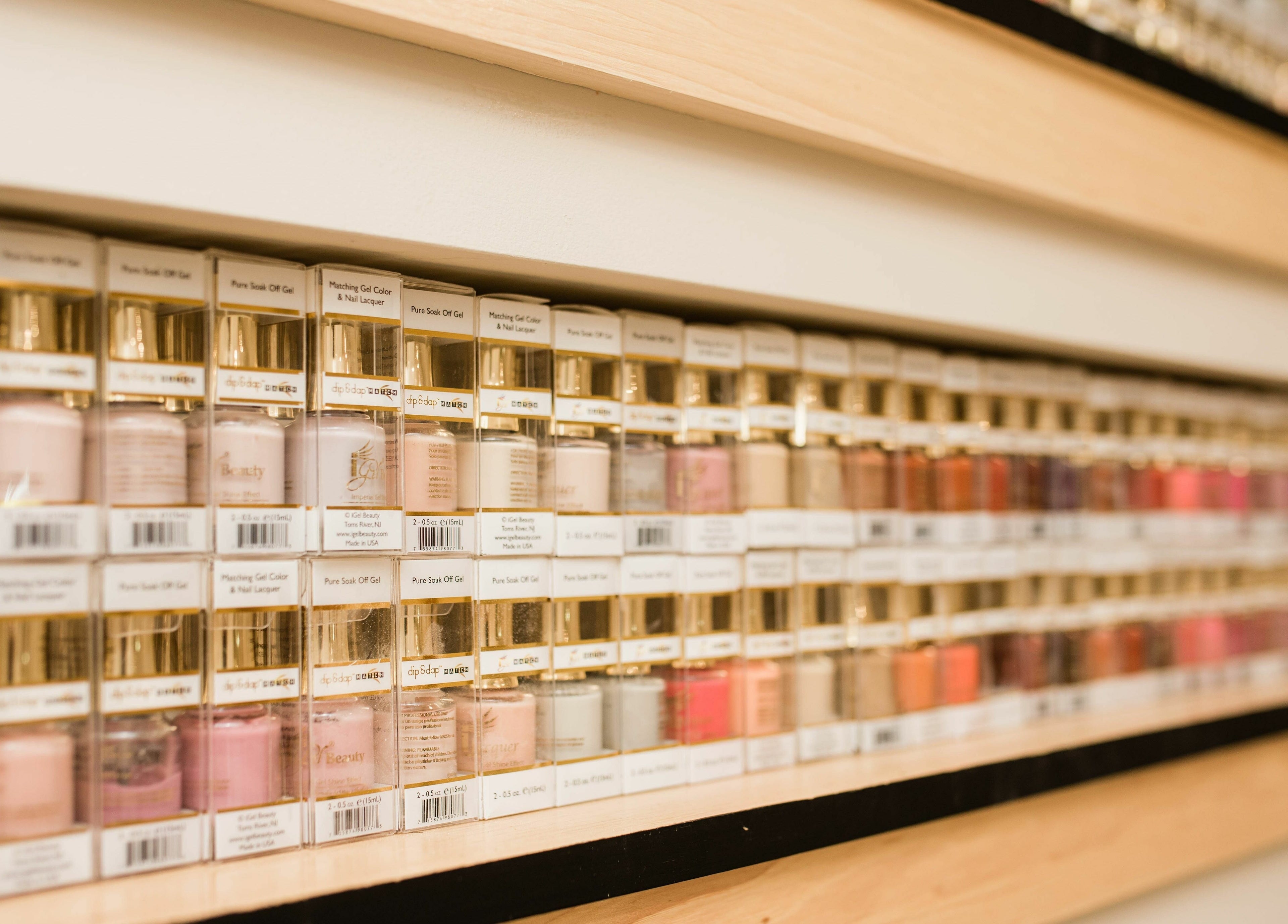 Colorful display of nail gels at The Babe Kave in Flint, Michigan, US, showcasing vibrant polish selection.