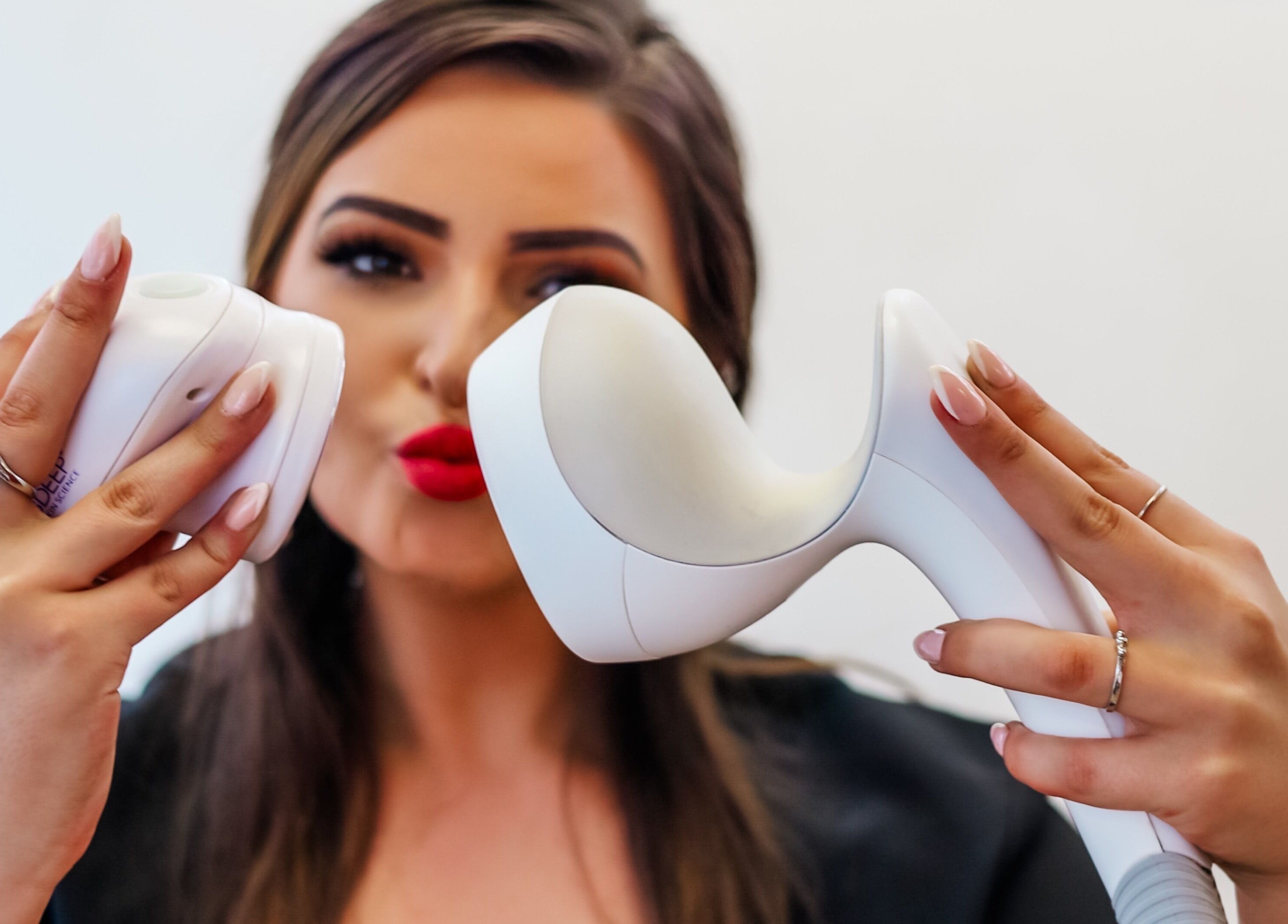 Professional showcasing beauty device at Young Again Aesthetics, Sandton, Gauteng, ZA.