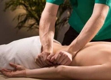 Therapist performs back massage at Functional Movement in Hermanus, Western Cape, ZA.