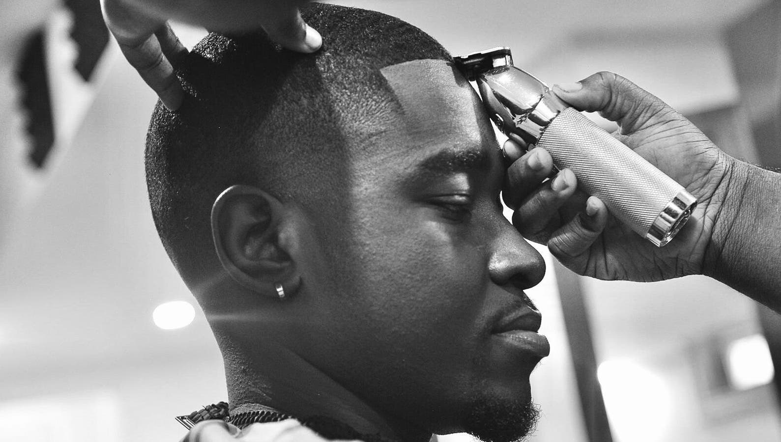 Close-up of a barber giving a haircut at Sid the Barber in Oshawa, Ontario, CA, showcasing expert grooming.