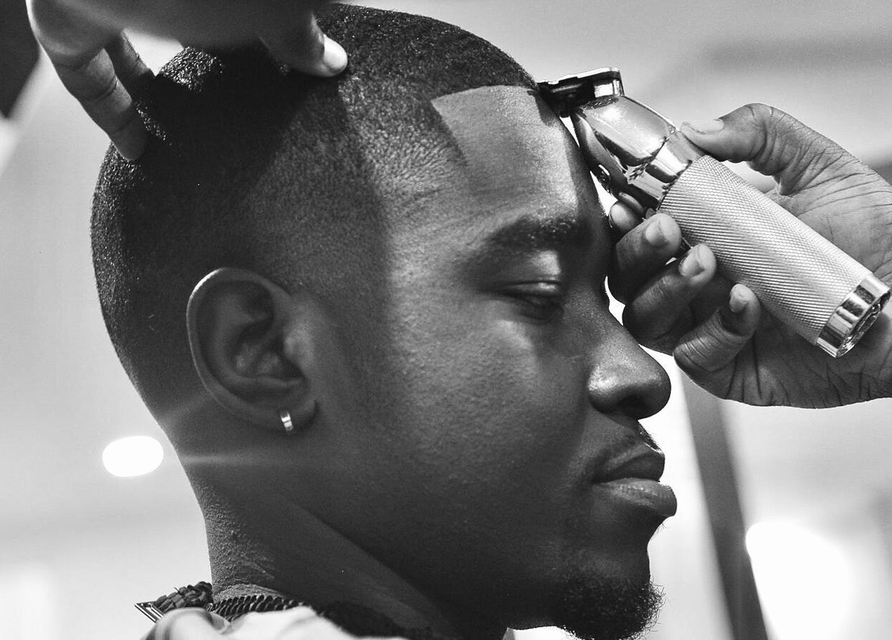 Close-up of a barber giving a haircut at Sid the Barber in Oshawa, Ontario, CA, showcasing expert grooming.